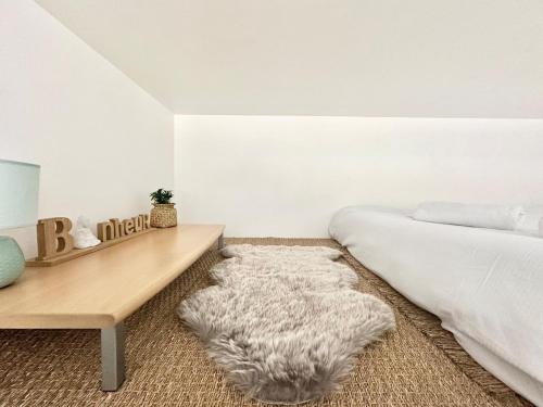 une chambre avec un lit et une table en bois dans l'établissement Studio mezzanine proche métro A, à Villeurbanne