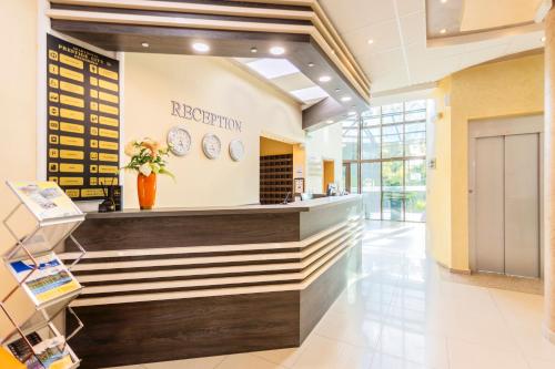 a lobby of a hospital with a reception counter at Aparthotel Hotel Prestige City II in Primorsko