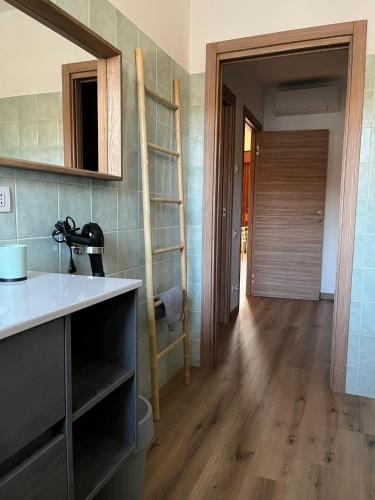 a kitchen with a sink and a wooden floor at Humanitas & Forum - CASA TUA Housing in Rozzano