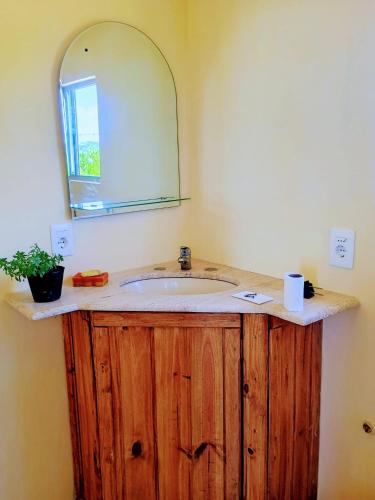 a bathroom with a wooden sink with a mirror at 28 de Octubre in Punta Del Diablo