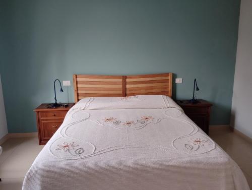 a bed with a white bedspread and two night stands at Short Lets Pescara in Pescara