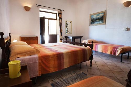 a bedroom with two beds and a window at Autentico Agri Salento in Morciano di Leuca