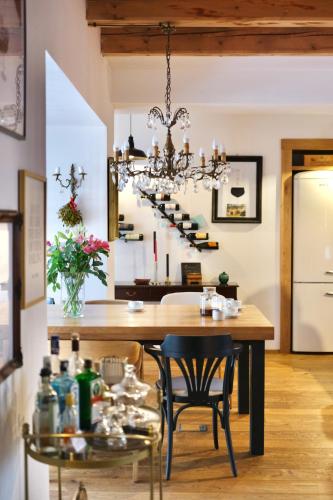 a dining room with a table and a chandelier at Casa Vacanze Černovice in Černovice