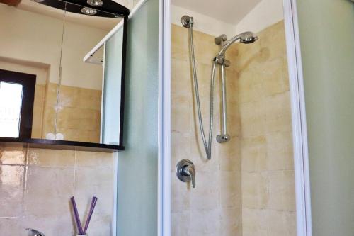 a shower in a bathroom with a glass door at Sotto al Portico - YourPlace Abruzzo in Rocca San Giovanni