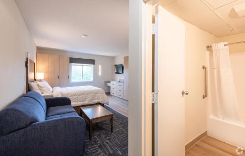 a living room with a couch and a bed at Residences at Solomon Pond in Marlborough