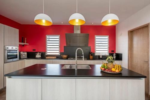 a kitchen with a sink and a bowl of fruit on a counter at Villa with pool in Ramena, sea view in Ramena