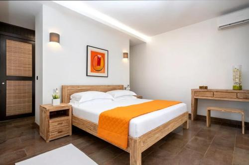 a bedroom with a large bed and a desk at Villa with pool in Ramena, sea view in Ramena