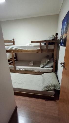 a room with three bunk beds on the wall at 2 dorm 100m Av Nacões Centrinho Facop USP in Bauru
