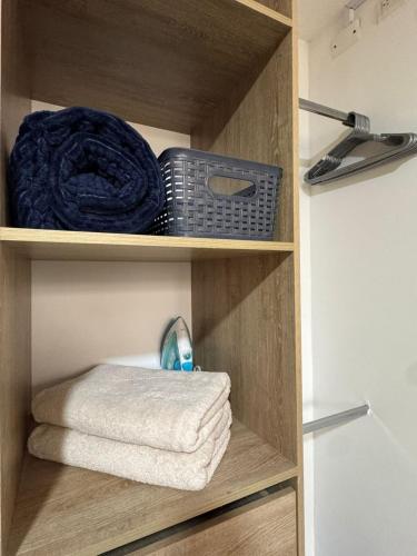 a towel and other items are on a shelf in a bathroom at Hostelfc San Luis in Bogotá