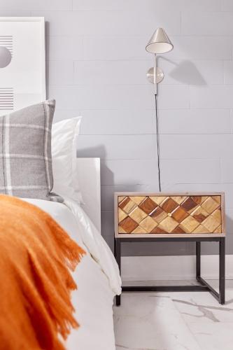 a bedroom with a bed and a table with a lamp at La TUMU in Toronto