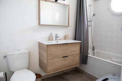 a bathroom with a toilet and a sink and a tub at CASA LEIA - À 4 min de la plage, avec Wifi in Sainte-Marie-la-Mer