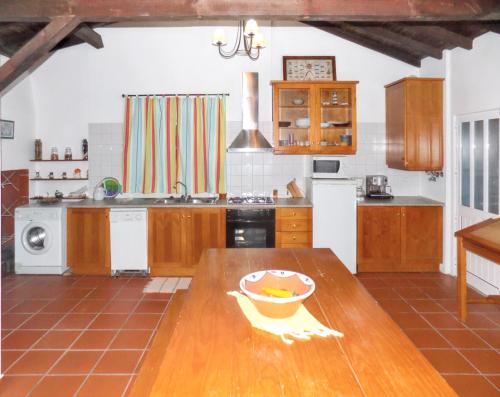a kitchen with a wooden table with a bowl on it at Charming House in Pataias with Shared Pool in Pataias