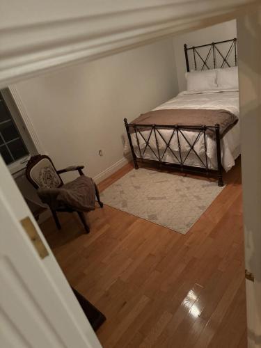 an empty room with a bed and a chair at Riverside Pool Chalet ! in Clarkes Beach