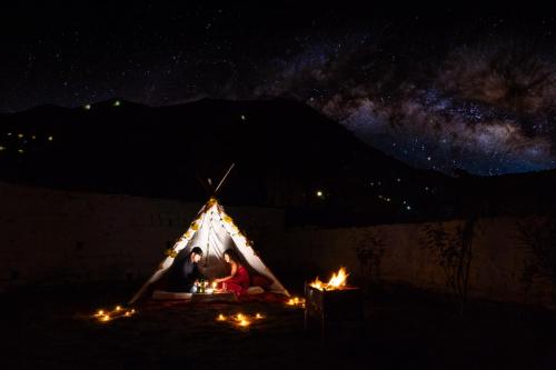 a couple sitting in a tent under the stars at Hill River Resort - Central Heated & Air Cooled - Near Mall Road , Best Property of Manali 2024- 2025 in Manāli