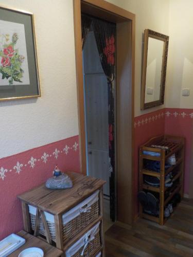a room with a door and a table and a mirror at Gartenblick in Mittenwald