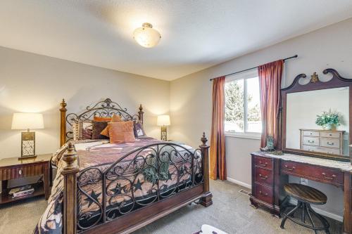 a bedroom with a bed and a dresser and a window at Loveland Home with Private Hot Tub and Wood Fireplace! in Loveland