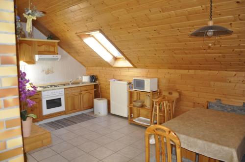 a small kitchen with a table and a stove at Ferienwohnung Anna Scheid in Kelberg