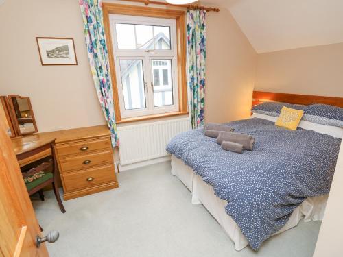 a bedroom with a bed with a teddy bear on it at Framingham in South Hayling