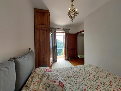 a bedroom with a bed and a chandelier at Casa Peppina in Strettoia
