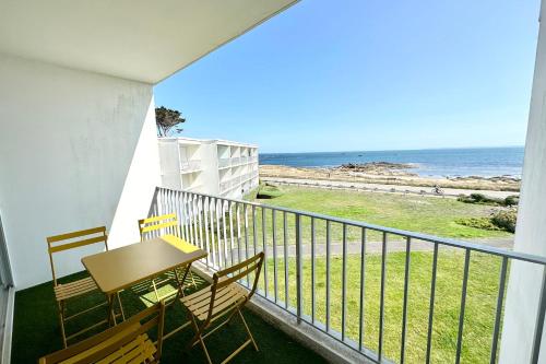un balcon avec une table et des chaises et l'océan dans l'établissement Appartement Top Cocooning Vue mer 180, à Quiberon