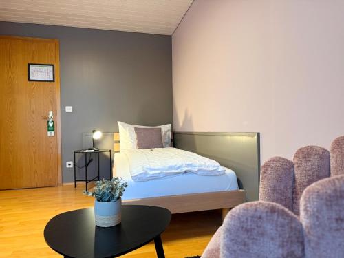 a bedroom with a bed and a table and chairs at Best Western Hotel Rebstock in Rorschacherberg