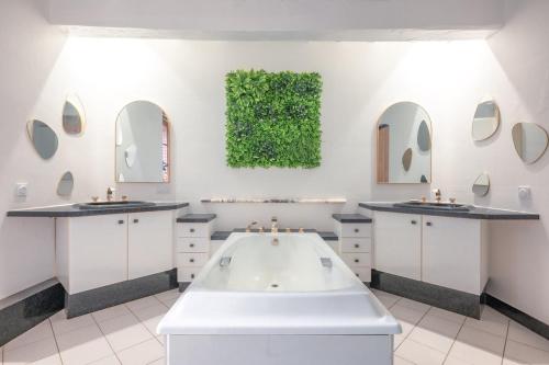 a bathroom with two sinks and a large tub at Moulin Bondon, group cottage - 14 beds in Graçay