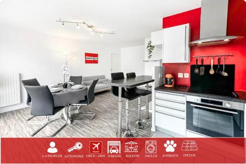 a red and white kitchen with a table and chairs at Balcon privé, parking gratuit, Orly 5 kms in Villejuif