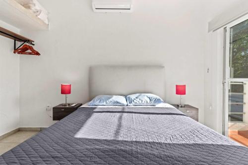 a white bedroom with a large bed with two lamps at Madison - 99 Steps to Beach in Golden Zone in Bucerías