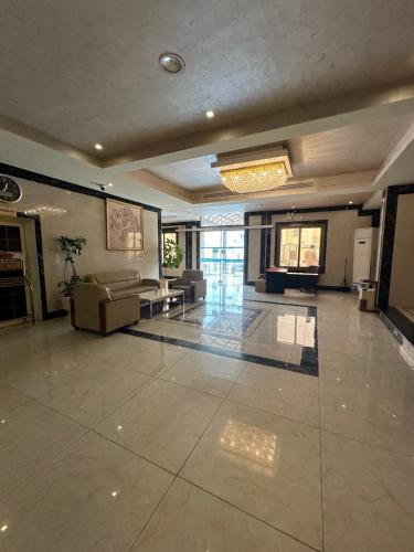 a large room with a lobby with couches at مسكن لؤلؤة الخليج للشقق المخدومة in Dammam