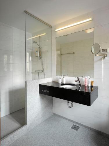 a bathroom with a sink and a mirror at Private luxury Villa BIANCO on Solta for up to 10 persons, heated pool, free parking, very close to the beach! FREE Kajak & Mountainbikes, GREAT living area & privacy! in Rogač