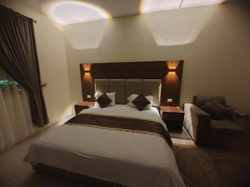 a hotel room with a bed and a couch at Al Eairy Apartments - Al Ahsa -2 in Al Ahsa