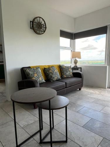 a living room with a couch and a table at Andy's Cottages at the Well in Hilltown