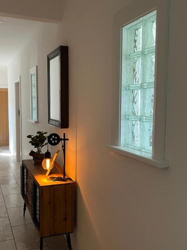 a room with a cross on a table and a window at Andy's Cottages at the Well in Hilltown