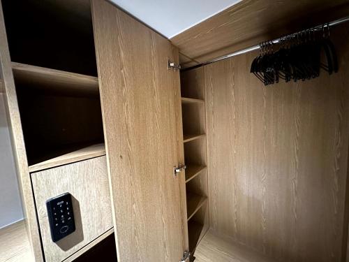 a cupboard with an open door with an object in it at Nomad Live Hostel in Busan
