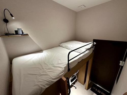 a small room with a bunk bed in it at Nomad Live Hostel in Busan