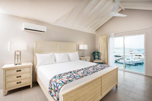 a bedroom with a bed and a view of a marina at Caravelle Hotel in Christiansted