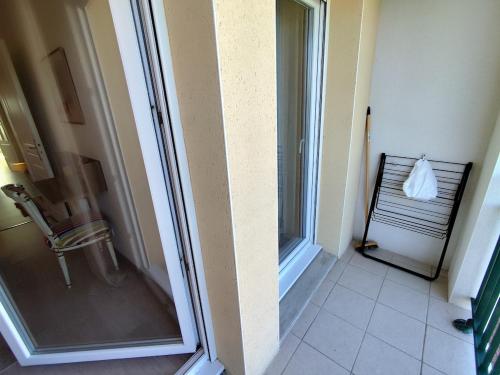 a bathroom with a sliding glass door and a window at Vue baie à l'infini in Le Crotoy