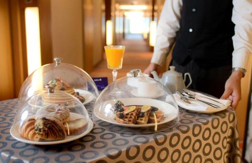 a table with several plates of food on a table at Radisson Blu Hotel Guwahati in Guwahati