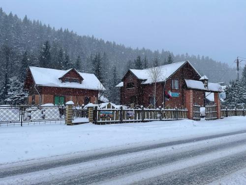 a couple of buildings with snow on them at Kryvorizka Palanka in Mykulychyn
