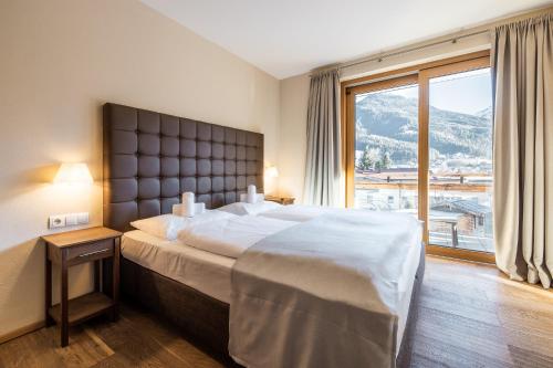 A bed or beds in a room at Wildkogel Resorts - DAS Wildkogel