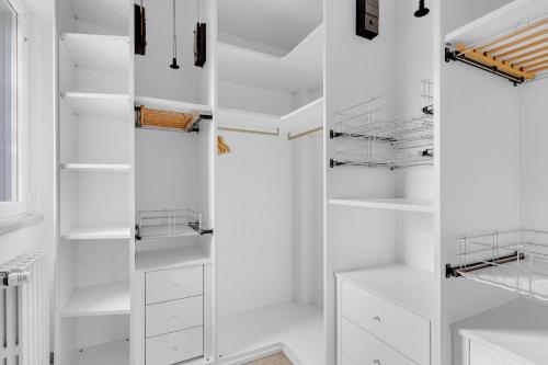 a white walk in closet with white shelves at MUG7 -Sesto San Giovanni - Prestige House - in Sesto San Giovanni