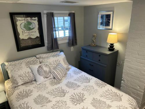 a bedroom with a bed and a dresser with a lamp at Cozy Unit in Milford, Delaware -Close to DE Turf in Milford