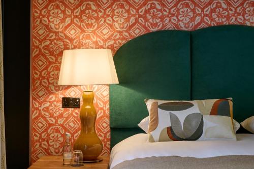 a bedroom with a bed and a lamp on a table at Hotel du Vin Bristol in Bristol
