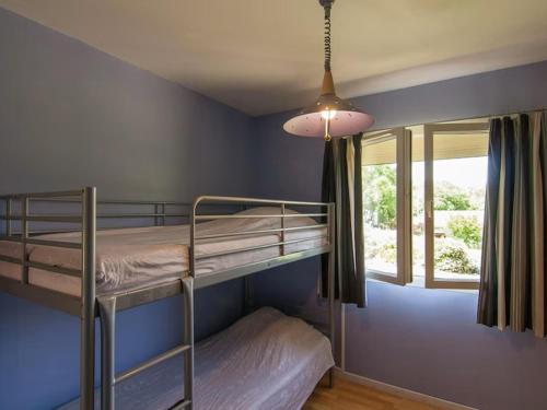 a bedroom with two bunk beds and a window at Villa Cethi in Boissières