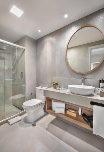 a bathroom with a toilet and a sink and a mirror at INNSiDE by Meliá São Paulo Iguatemi in Sao Paulo
