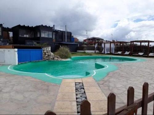 a small pool with green water in a yard at DIVMAR APART Santa Clara del Mar in Santa Clara del Mar