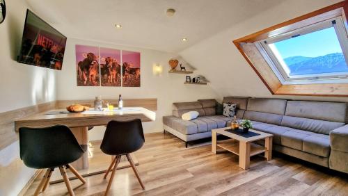 a living room with a couch and a table at Ferienwohnungen Wolf - Wohnung "Falkenstein" mit 3 Zimmer in Pfronten