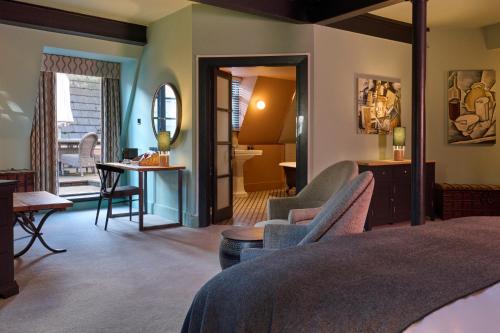 a bedroom with a bed and a table and chairs at Hotel du Vin Bristol in Bristol