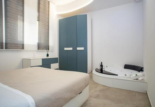 a bedroom with a bed and a bath tub at Urban Suite - The Fab Stay in Brindisi