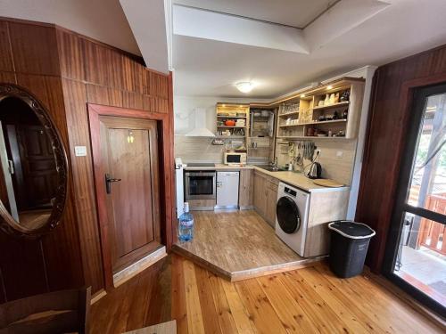 a kitchen with a washer and dryer in it at Дядо Добревата къща in Tryavna
